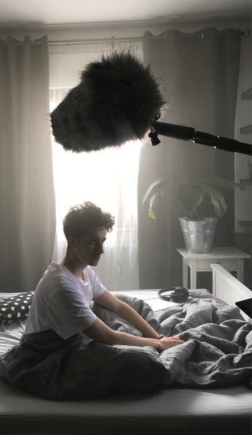VISUELL Kommunikationsdesign: Kino-Werbespot für STAHL CraneSystems: Der Hauptdarsteller sitzt im Bett, man sieht ein Mikrofon