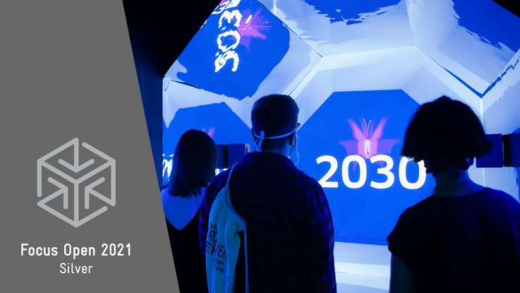 VISUELL Szenografie: Escape-Ausstellung: Besucher stehen im blauen Zeitzug auf dem Weg ins Jahr 2030