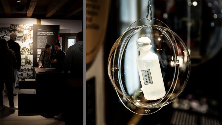 VISUELL Scenography: Permanent exhibition at Hornmoldhaus: Left: Visitors at a media station in front of the large-format wall panel on the theme of merging and growing together; right: detail of an exhibit in a transparent spherical display case with a historical product bottle.